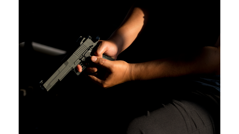 Midsection Of Man Holding Gun