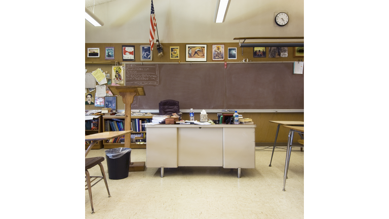 Classroom with teacher's desk in middle of room