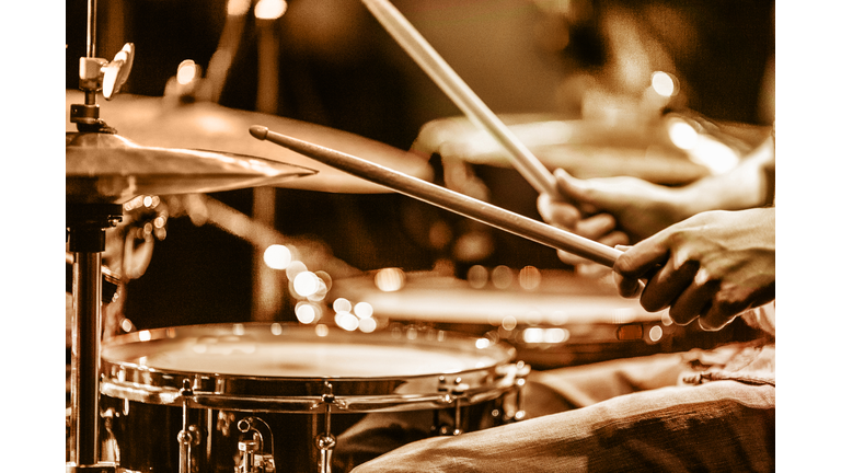 Drummer playing drums on stage