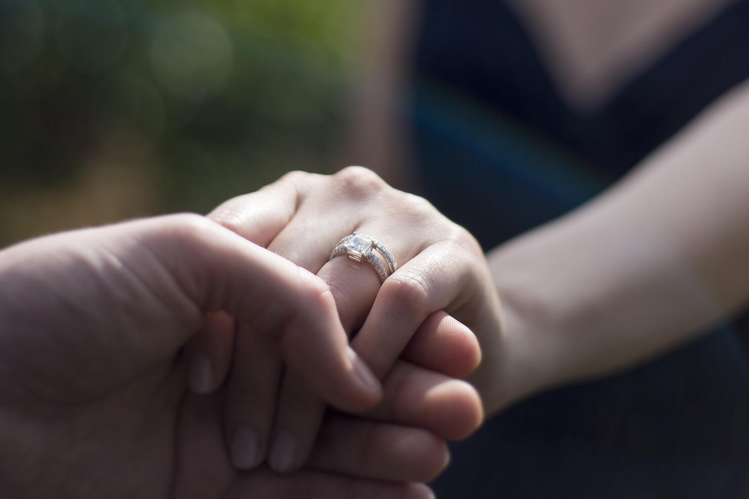 Close Up Holding Hands with Engagement Ring