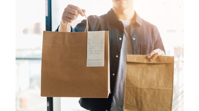 Man Delivering Takeaway Food At The Front Door