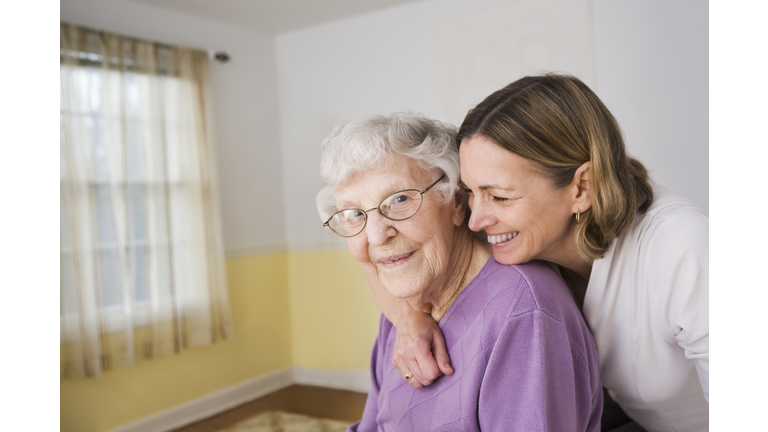 Daughter hugging Elderly mother