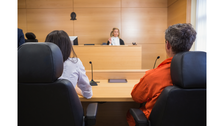 Lawyer and client listening to judge