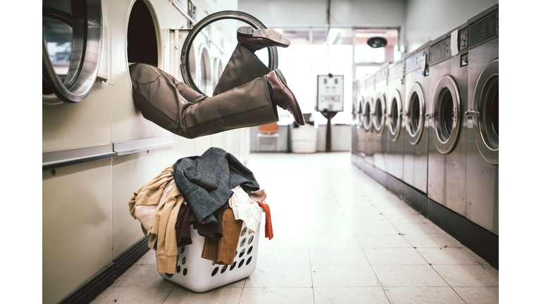 Man Washing Clothes at Laundromat
