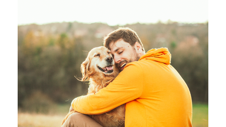 Guy and his dog, golden retriever, nature