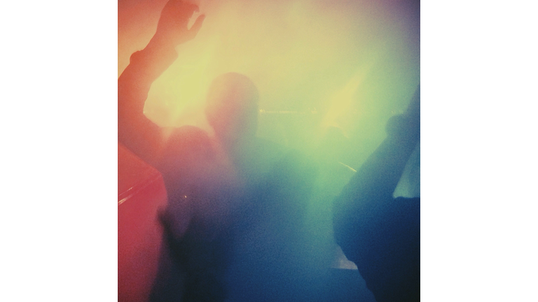 Defocused People Dancing In Nightclub