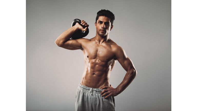 Young muscular man doing gym workout
