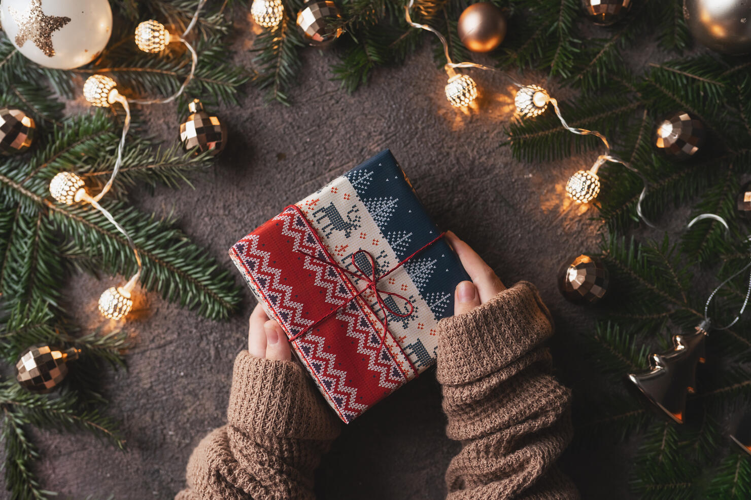 Woman making beautiful Christmas gift at table
