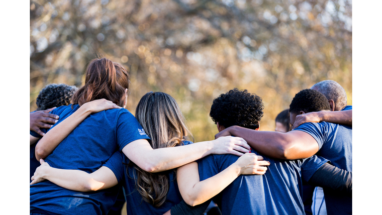 Friends linking arms in unity