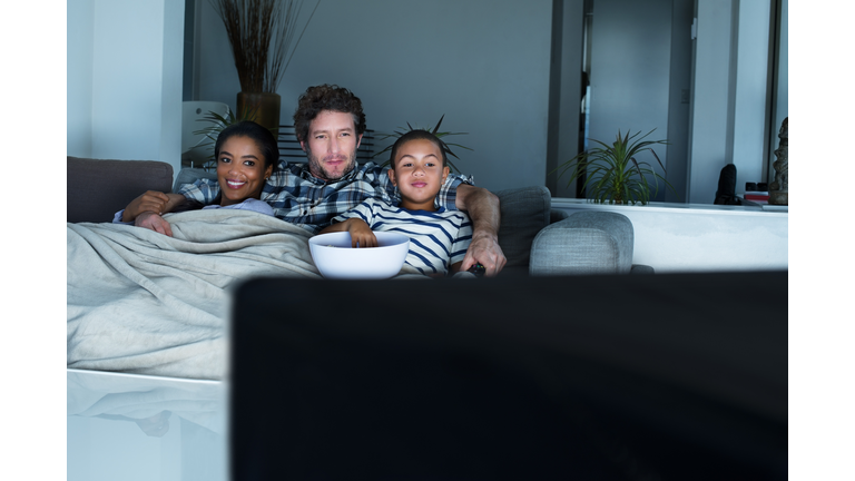 Family having popcorn while watching TV