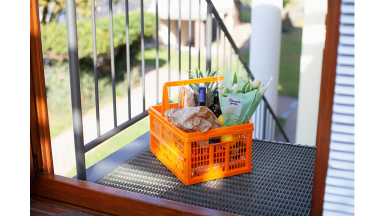 Neighborly help: A basket full of groceries left at the door