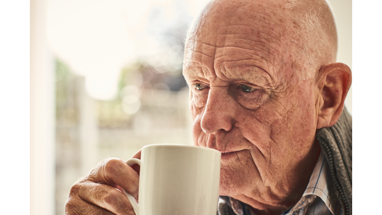 Elderly man at home drinking coffee