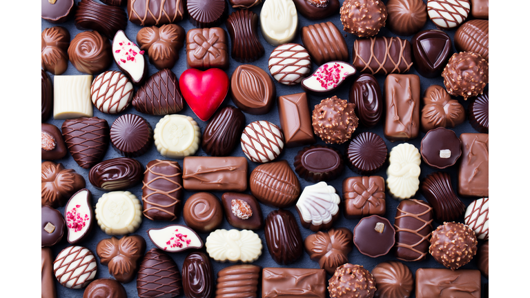 Assortment of fine chocolate candies, white, dark, and milk chocolate Sweets background. Copy space. Top view.