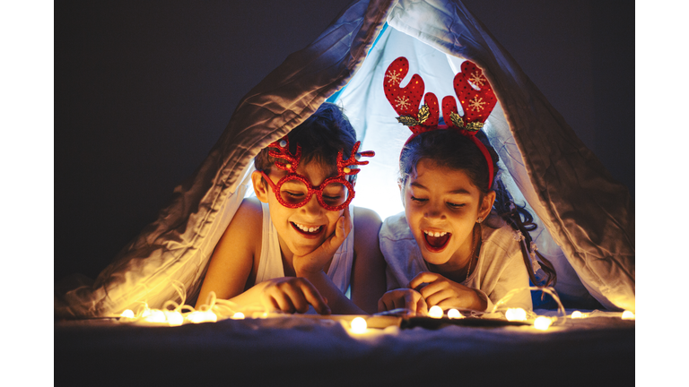 Happy kids are waiting for a New Year at home.