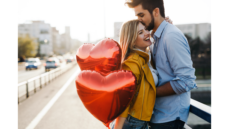Romantic young couple in love, hugging on the street