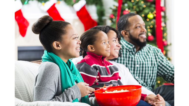 Happy African American family watch a Christmas movie