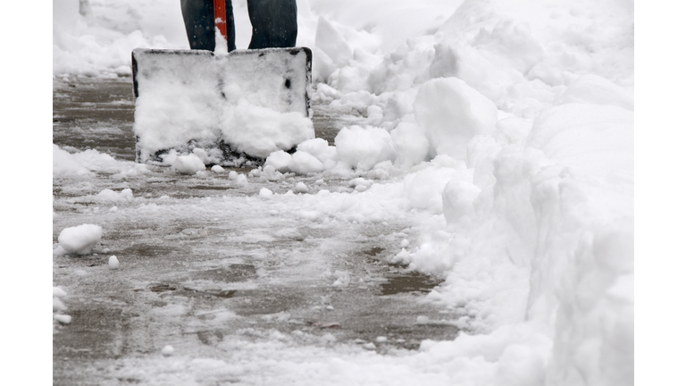 Shoveling Snow from Sidewalk