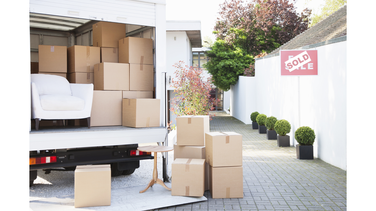 Boxes on ground near moving van