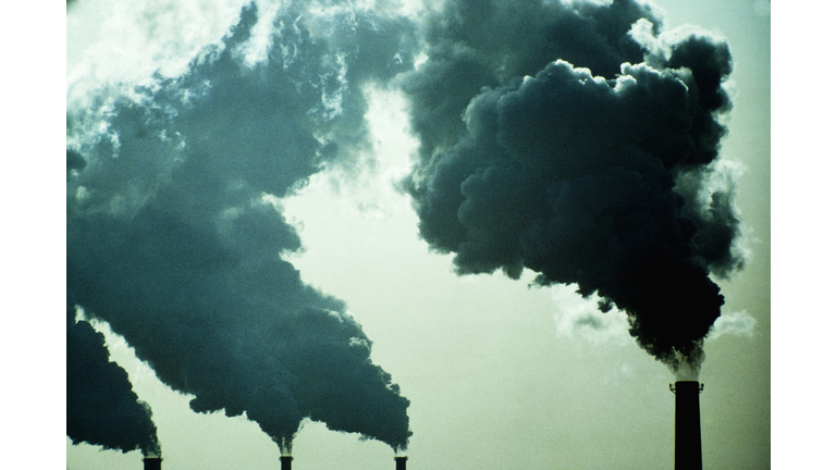 Smoke billowing from industrial smoke stacks