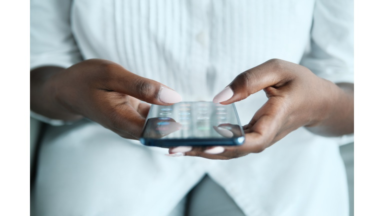 Black Woman Searching Application On Smartphone