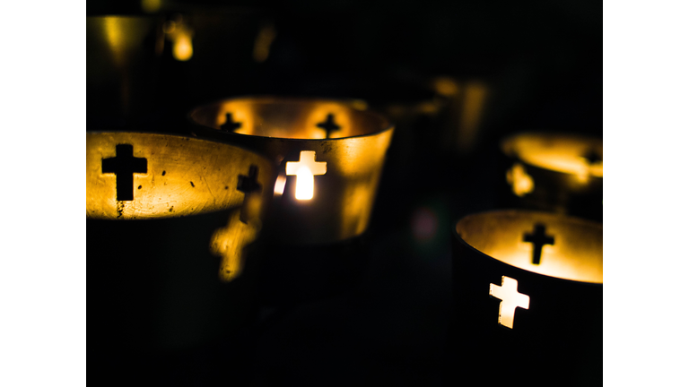 Close-Up Of Illuminated Candles In Church