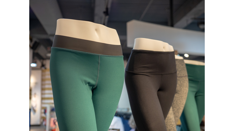 Plastic athletic mannequin lower bodies posing with yoga pants