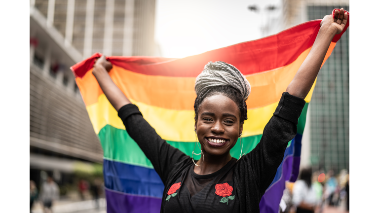 Woman Waving Rainbow Flag at Gay Parade