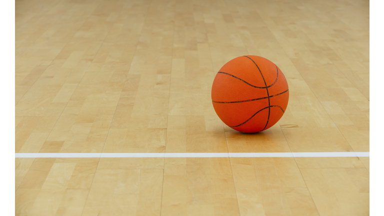 Basketball ball over floor in the gym. Team sport.