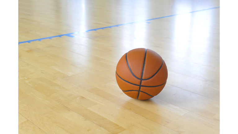 Basketball ball over floor in the gym. Team sport.