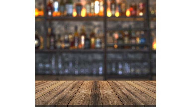 Bar with blurred lights bokeh and wooden table
Bar with blurred lights bokeh and wooden table