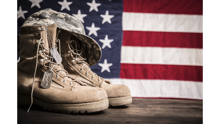 American Veteran's Day theme with military boots, hat, USA flag.