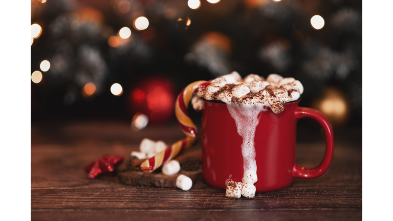 wooden desk space red mug and xmas tree