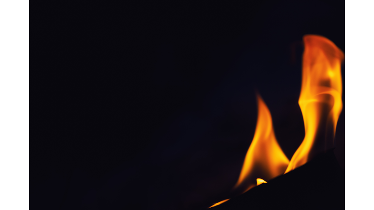 Close-up of fire against black background.