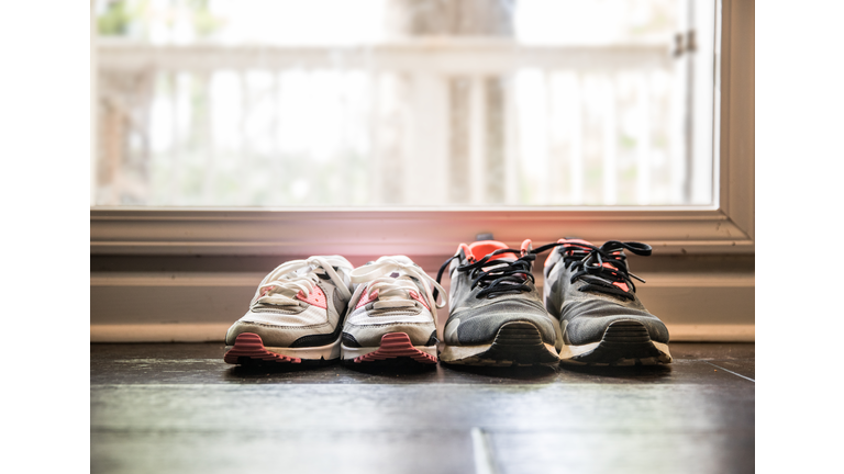 Still life of different size shoes on floor at home