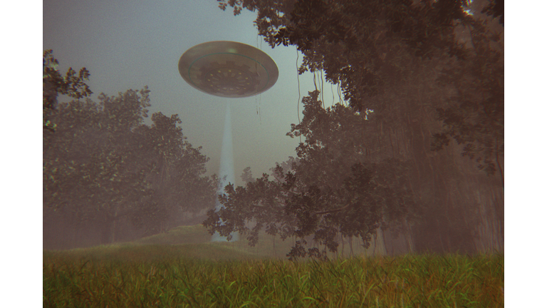 UFO flying over forest at night