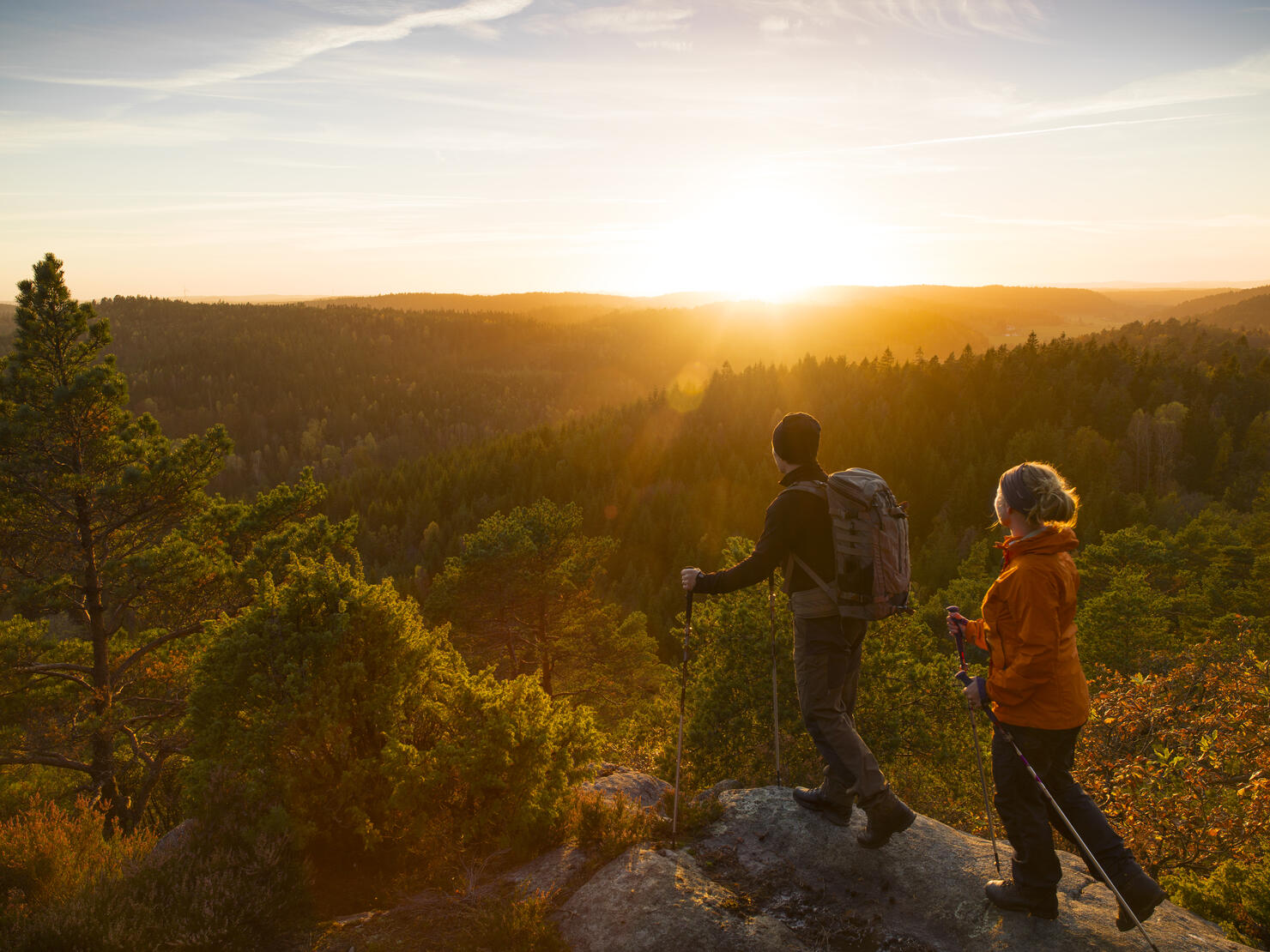 Man and woman hiking at sunset