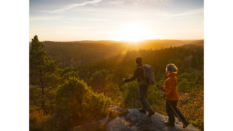 Man and woman hiking at sunset
