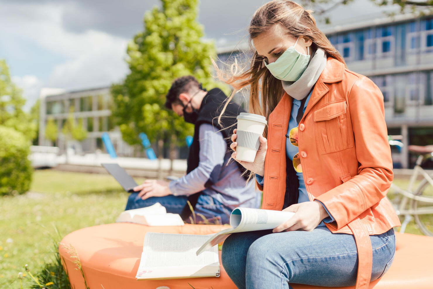 Woman student on college campus learning wearing face mask