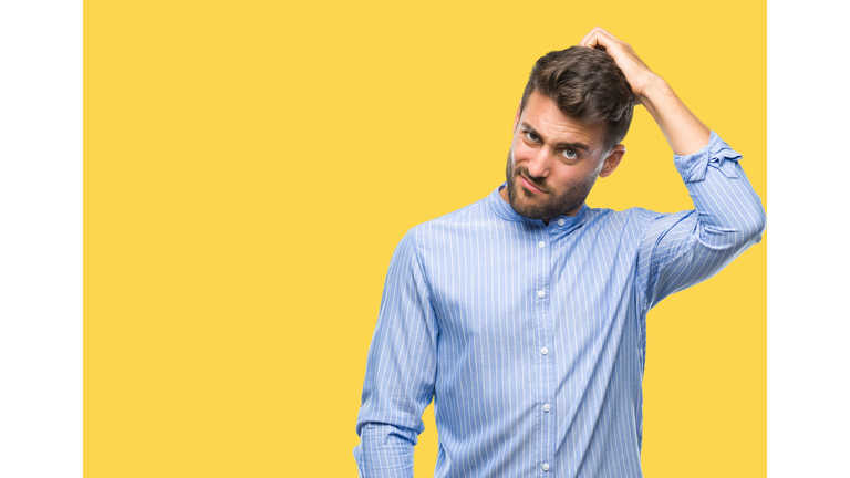 Young handsome man over isolated background confuse and wonder about question. Uncertain with doubt, thinking with hand on head. Pensive concept.