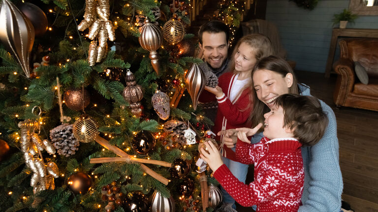 Banner view of happy family with kids decorate Christmas tree