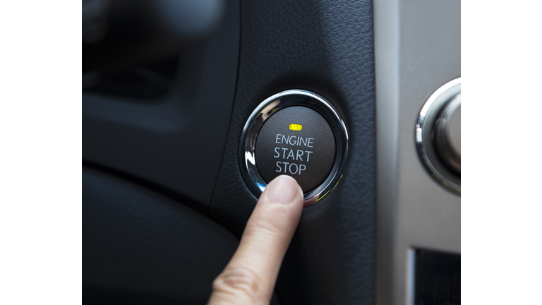 finger pressing the Engine start stop button