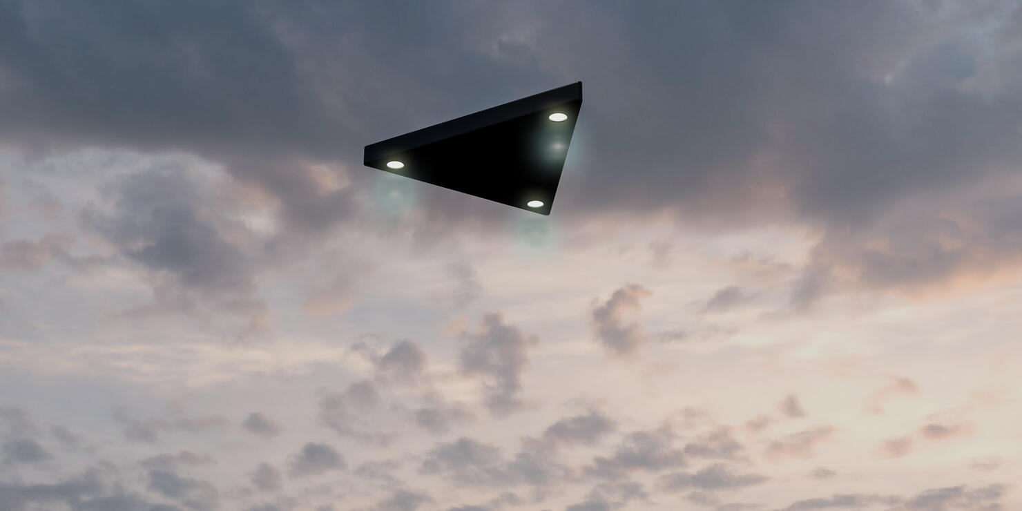 Triangular shaped ufo flying in the sky
