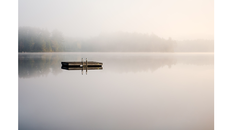 Scenic View Of Lake Against Sky During Foggy Weather