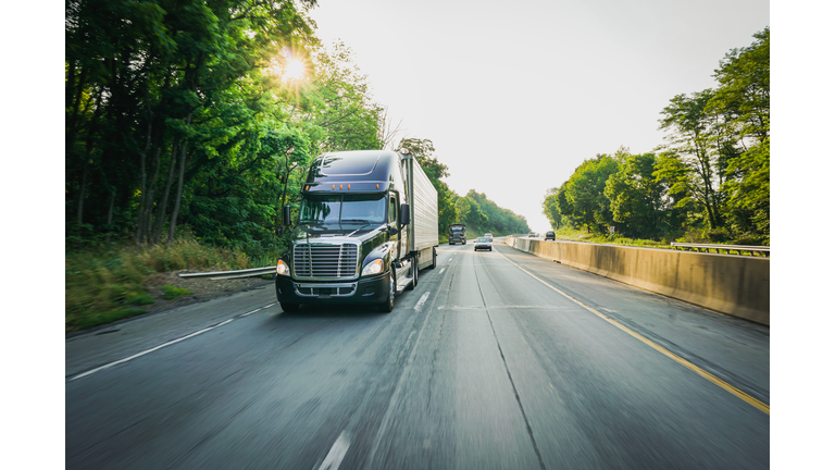 18 wheeler commercial freight truck on the road at dawn