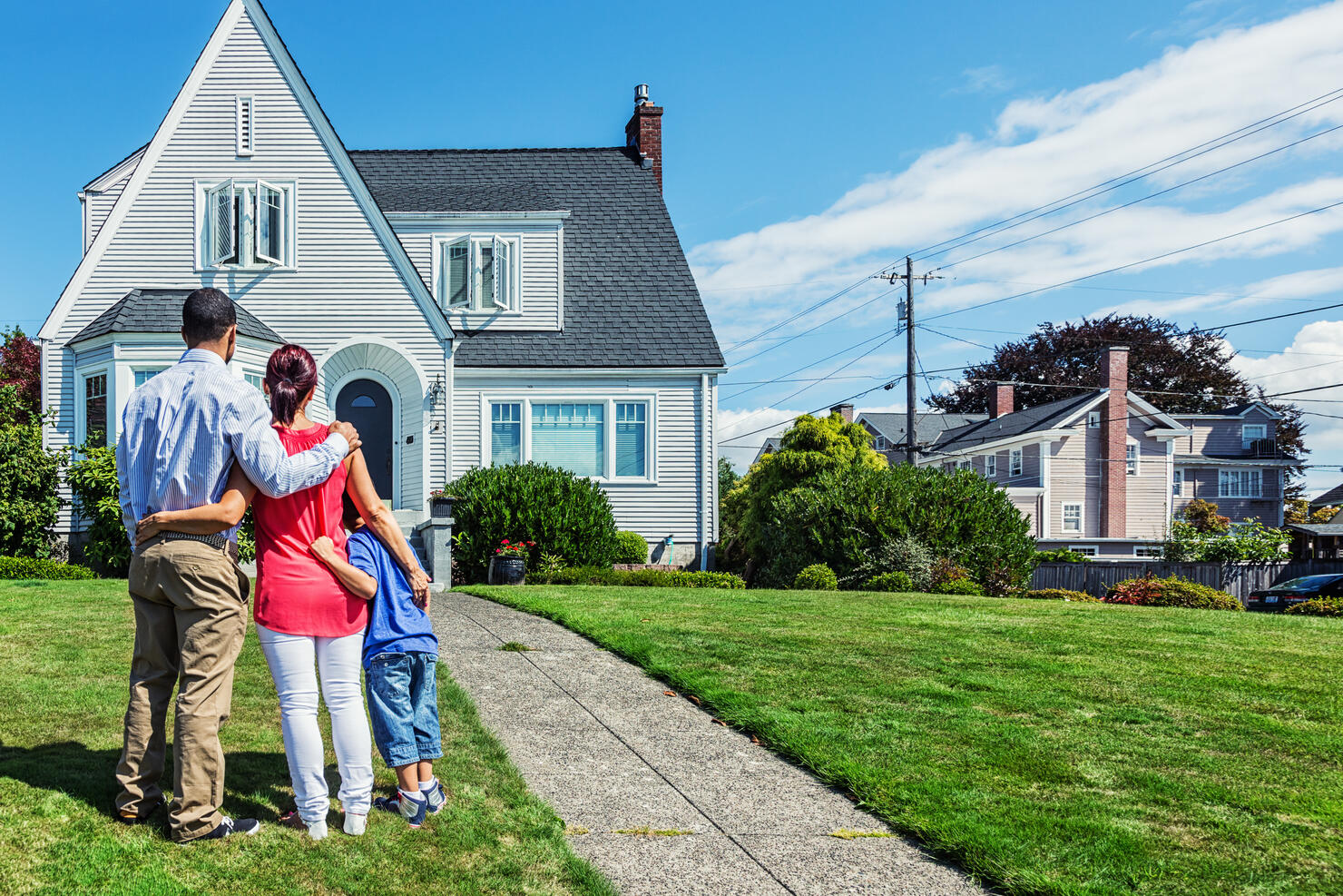 Happy Young Family Admiring Home