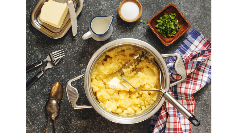 Mashed potato in cooking pan on wooden table