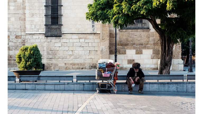 Homeless with his cart at the street