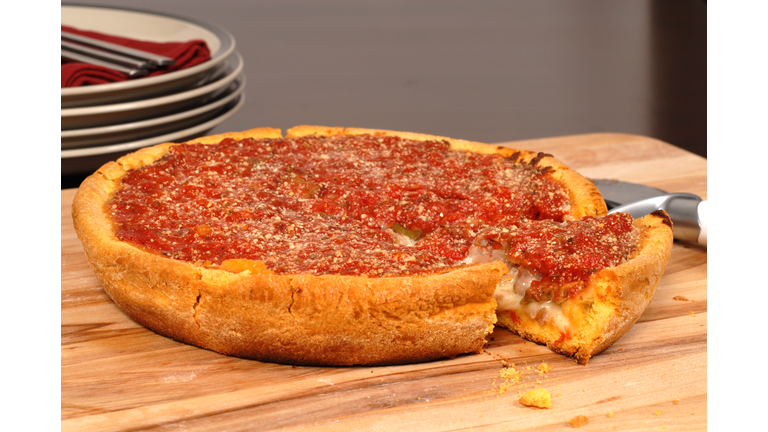 Chicago style deep dish pizza with a piece cut out