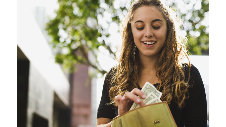 Teen removing money from wallet