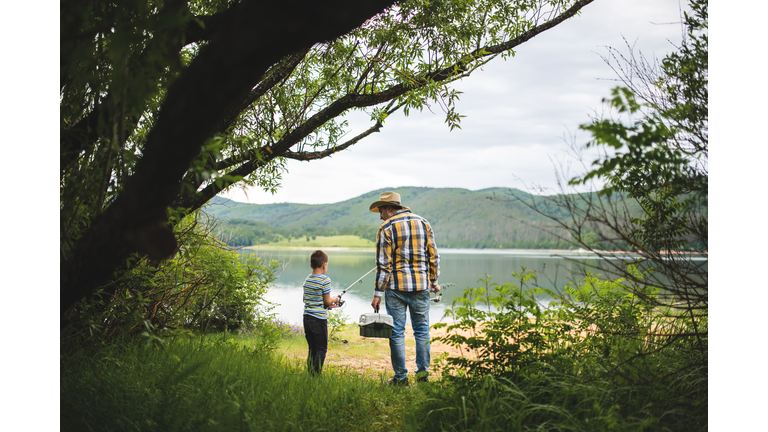 a little boy and his father go fishing